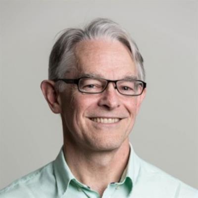 Headshot of David Thorburn wearing a light green collared shirt