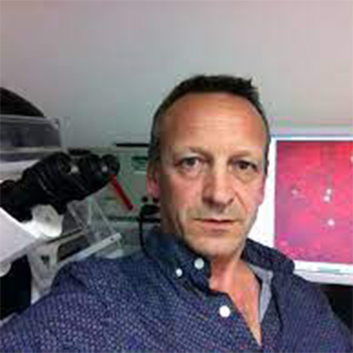 Guy Brown next to a microscope