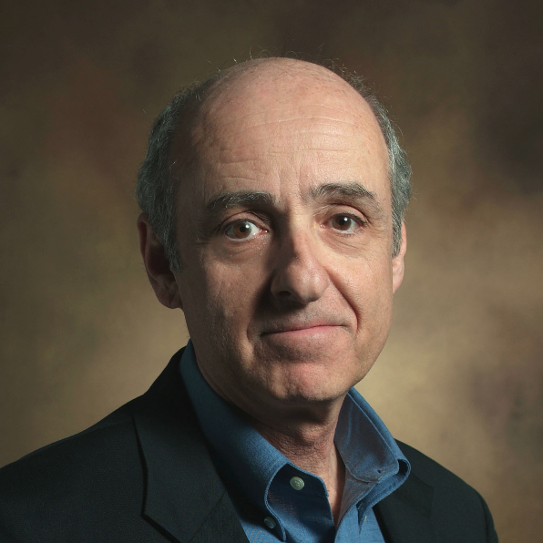Headshot of Sidney Hecht wearing a blue collared shirt and a dark blazer